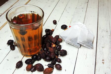 drink from the hips in glass cup on wooden backgroundの写真素材