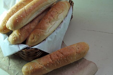 some fresh buns piled up on a wooden surface
