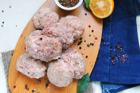 Raw meatballs with spices, preparing for fryingの写真素材