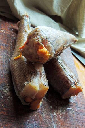 Frozen sea fish on the Board, preparing for cooking, heck