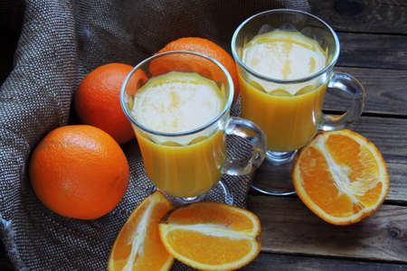 Orange and orange juice on wooden background