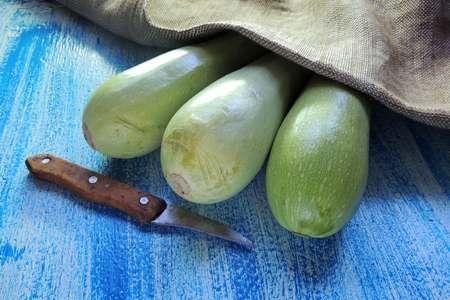 Green young zucchini on a dark stone background. Geometric layoutの写真素材