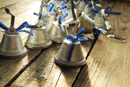 Bells with Christmas decoration on wooden backgroundの写真素材