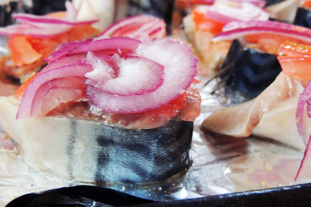 Process of preparation of mackerel in foil. Fresh fish for baking is stuffed with vegetables and sour cream. Healthy and healthy seafood.の写真素材