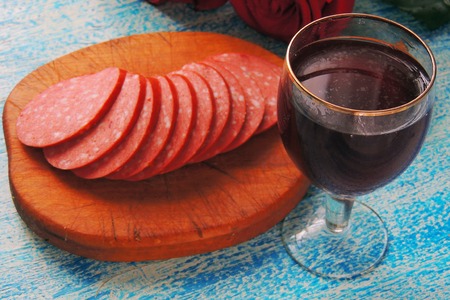 Glass of red wine with charcuterie assortment on the backgroundの写真素材