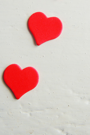 Wooden white background with red hearts, gifts and candles. The concept of Valentine Day.の写真素材