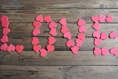 Wooden white background with red hearts, gifts and candles. The concept of Valentine Day.の写真素材