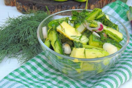 Japanese cucumber salad with black and white sesame seeds in mason jar with lid on concrete round tray, grey background decorated by lace ribbonの写真素材