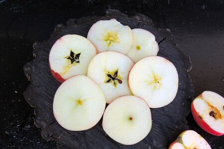 ripe apples on a black background and in a cut
