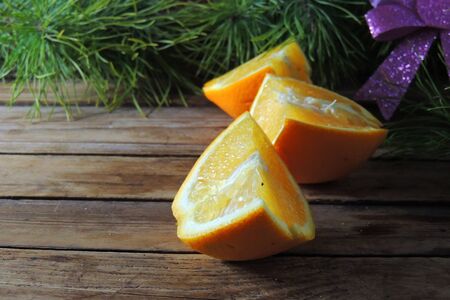 christmas concept with Tangerines, Fir , lights ,Snow, boke and snowflakes, on wooden backgroundの写真素材