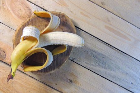 Bananas on and old vintage table top with modeled tan background for a rustic feel and copy spaceの写真素材