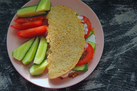 Pancake with oatmeal with red fish, tomato and herbs