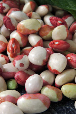 Young soy beans or edamame on wood plate. White background.