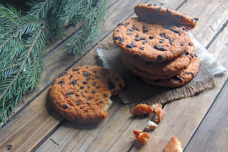 glass of milk and cookie on wooden background