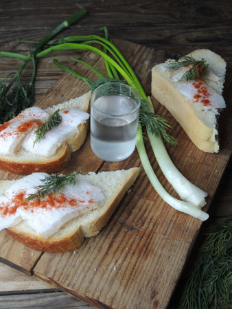 Sandwich with salted herring, dill and vodka.の写真素材