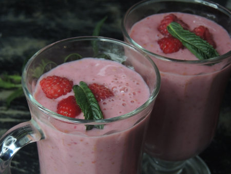 Strawberry smoothies with mint and raspberries in a glass
