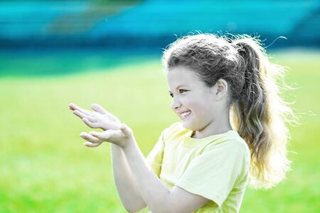 little pretty girl overflowing with happy emotions doing sport activities at summerの写真素材