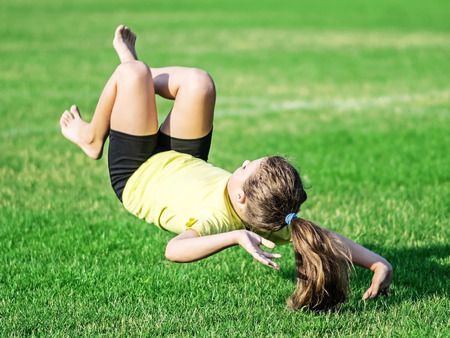 little girl doing somersault and Lost balanceの写真素材