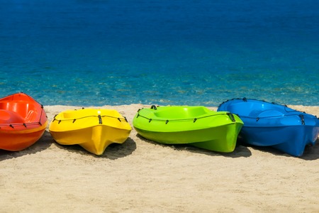 Colorful kayaks on white sand on beach of Cyprus against of the blue sea background. Bright Summer Seascape.の写真素材