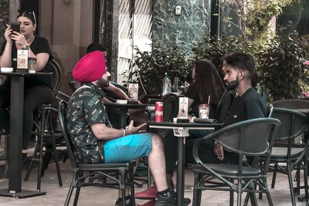CYPRUS, NICOSIA - JUNE 10, 2019: People sitting in a summer outdoor restaurant on a city streetのeditorial素材