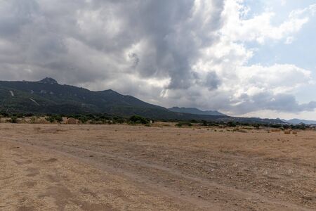 View of Northern Cyprus. The nature of the Mediterranean. A round bale of straw for animal feed. Forage for livestock. Cloudy weather.の写真素材