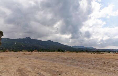 View of Northern Cyprus. The nature of the Mediterranean. A round bale of straw for animal feed. Forage for livestock.の写真素材