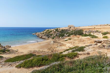 Mediterranean Sea in Northern Cyprus. The ruins of an ancient building on the island. Summer seashore with transparent blue water. Seascapeの写真素材