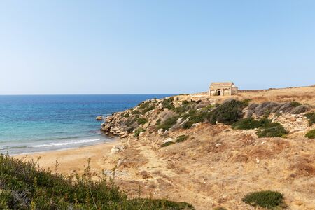 Mediterranean Sea in Northern Cyprus. The ruins of an ancient building on the island. Summer seashore with transparent blue water. Seascape. Skyline.の写真素材