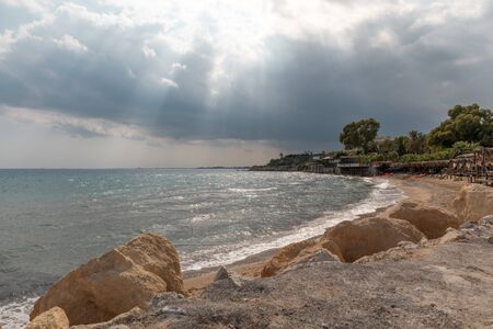 Mediterranean Sea in Northern Cyprus. Summer seashore with transparent blue water sun rays in the clouds. Coastline.の写真素材