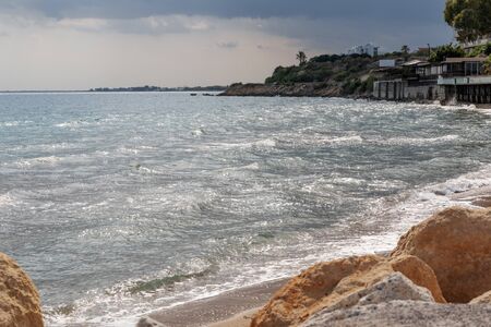 Mediterranean Sea in Northern Cyprus. Summer seashore with transparent blue water sun rays in the clouds. Seascape. Skylineの写真素材