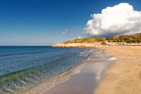 Mediterranean Sea in Northern Cyprus. Summer sandy coast, transparent calm blue water and white clouds on blue sky. Seascape. Skylineの写真素材