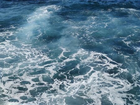 View of the sea waves from above. Sea water with foam.の写真素材