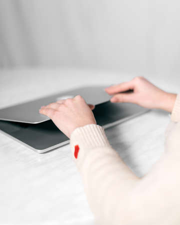 Close up of female hands on a laptop opening the device to get startedの写真素材