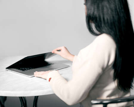 Portrait from the back Business lady working at the office table using laptopの写真素材