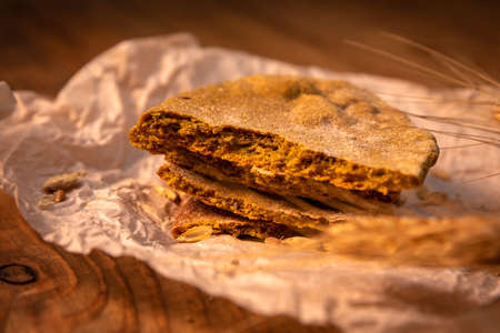 Made by hand fresh tortillas on parchment paper on the wooden table.の写真素材