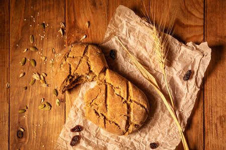 fresh bread and wheat on the wooden table.の写真素材