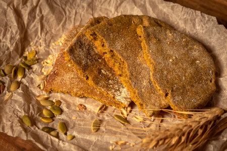 fresh bread and wheat on the wooden table.の写真素材
