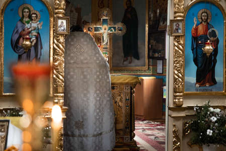 Pokrov, Ukraine - January 24, 2021: Church of St. John Chrysostom. Interior of an Orthodox Ukrainian church. The priest prepares for the ceremony of the Sacrament of the Wedding.のeditorial素材