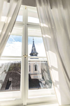 White wooden classic window with curtains and prague view