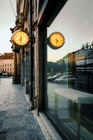 Prague, Czech Republic, March 9, 2022: Big luminous clock on The Old Town Square is reflecting on glass case.のeditorial素材