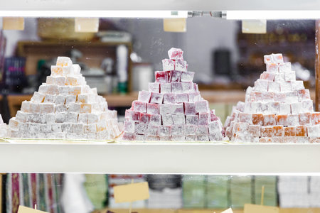 Traditional Turkish delights or lokum at the market counter. Shop window with Eastern sweets.の写真素材