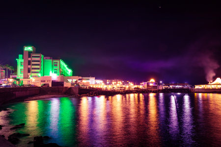 Cyprus, Girne, Kirenia - April, 2023: Kirenia city, sea coast, night street lights reflected in the waterのeditorial素材