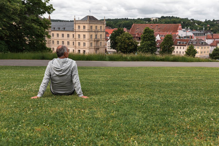 Panoramic view of Ehrenburg Palace in Coburg with elderly man sitting and admiringの写真素材