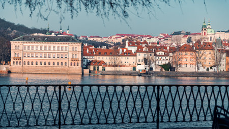 Scenic Riverside View with Traditional Czech Architecture on Sunny Autumn Dayの写真素材