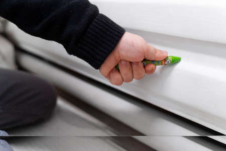 Close up baby hand drawing heater