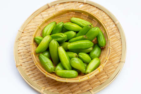 Bilimbi fruit in bamboo basket on white background.の写真素材