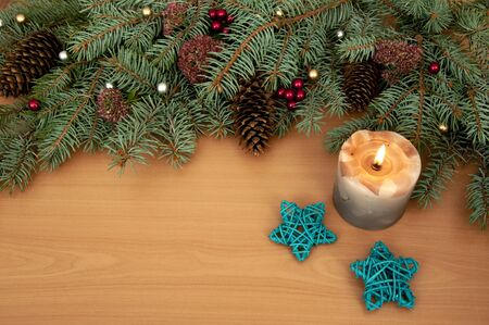 Christmas background. Christmas tree branches, gift, hearts, balls, candle and stars on wooden textureの写真素材