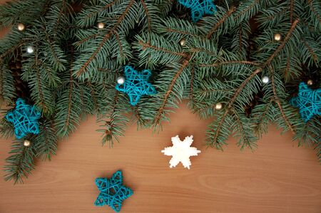 Christmas background. Christmas tree branches, gift, hearts, balls, candle and stars on wooden textureの写真素材