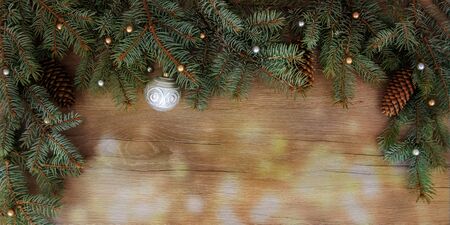 Christmas branches, cones, decorations on a wooden texture. Holiday Christmas backgroundの写真素材