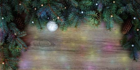 Christmas branches, cones, decorations on a wooden texture. Holiday Christmas backgroundの写真素材